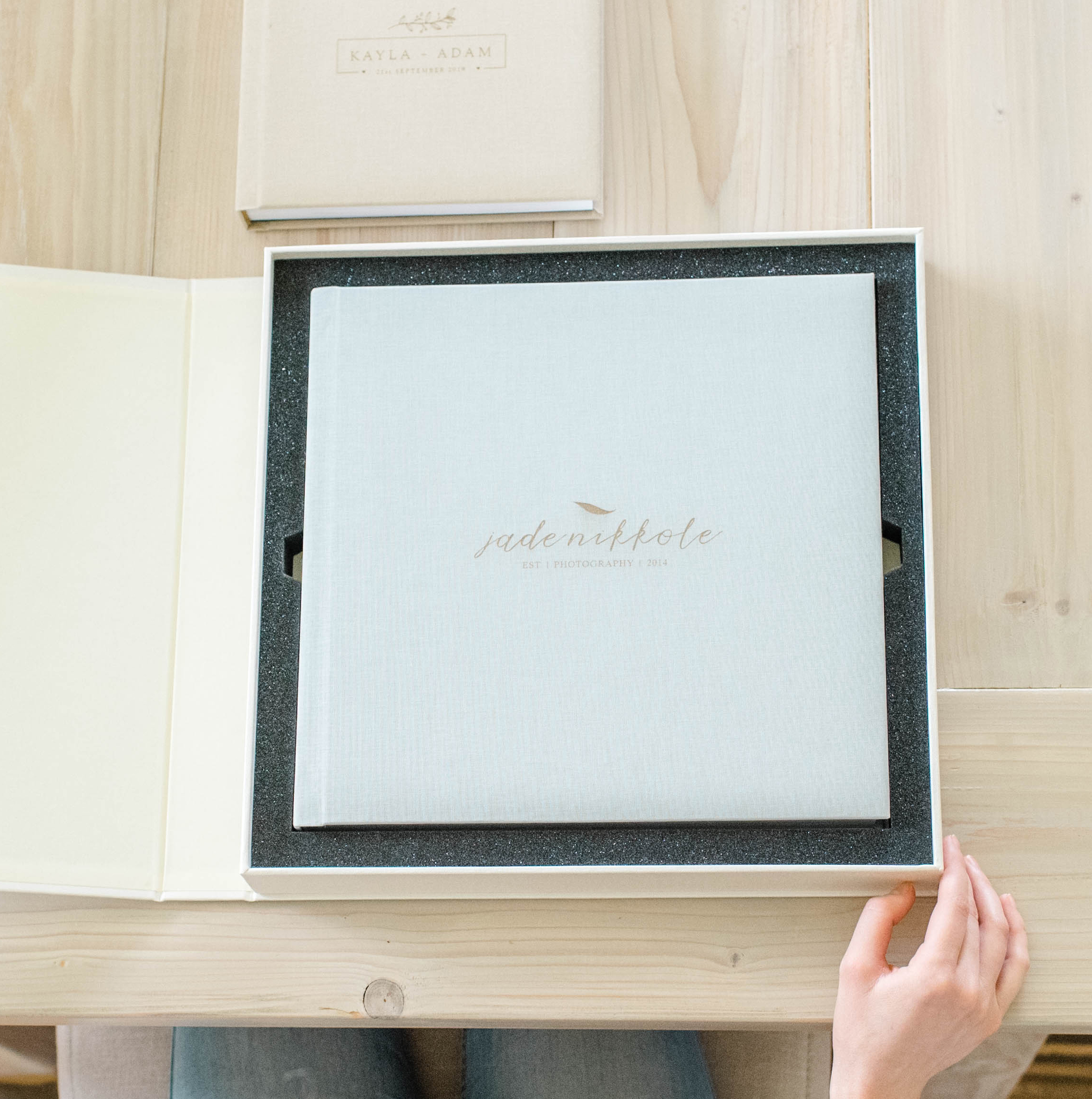 Women viewing a photo book presentaion box on table