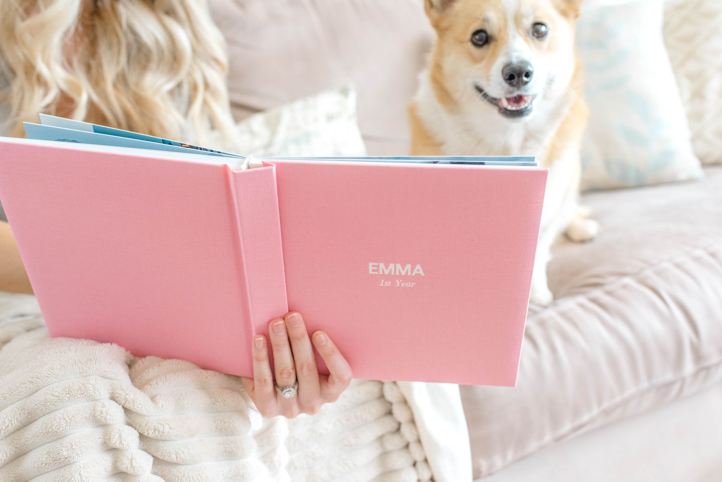 Women holding pink linen baby photo book