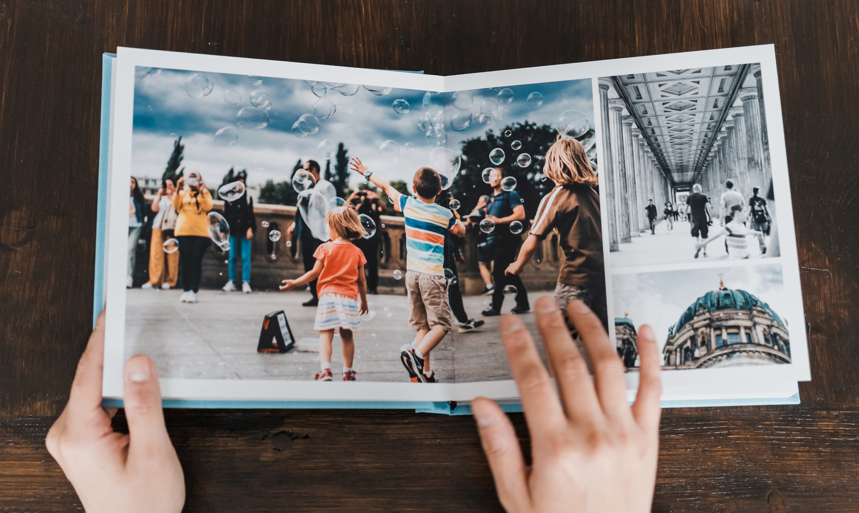 Luxury travel photo book on rustic wooden table